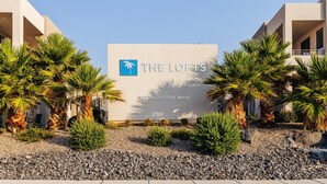 A building with a sign reading "THE LOFTS" and an address "1122 South 1790 West". - The Lofts 2|Community Pool w/water slide and hot tub, grill, Smart TV (Saint George)