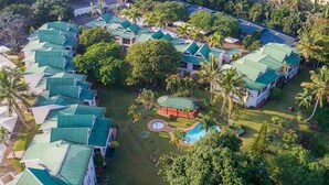 An aerial view of a resort with multiple buildings, a swimming pool, and lush greenery. - Luxury Apartment St Lucia 43 On the Bridge (Saint Lucia)