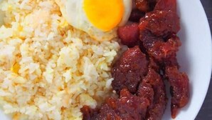 A plate with fried rice, a fried egg, and a portion of meat. - Max Travellers Inn (Lapu-Lapu)