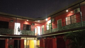 A two-story building with a red exterior and a balcony on the upper floor. - Max Travellers Inn (Lapu-Lapu)