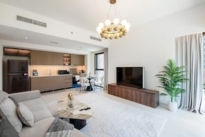 A modern living room with a sofa, coffee table, and TV.