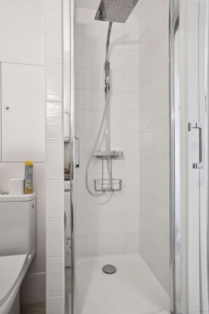 Enjoy a refreshing shower experience with a handheld and overhead showerhead, and a convenient wall-mounted control panel.