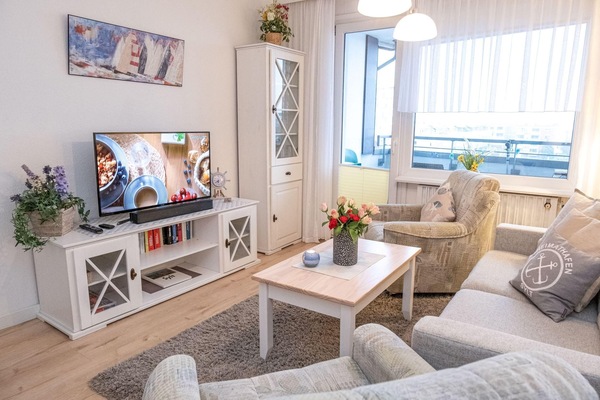 hell und freundlich eingerichteter Wohnbereich mit großem Flachbildfernseher und neuem Laminat-Fußboden in der Wohnung 28 des Haus Anke...