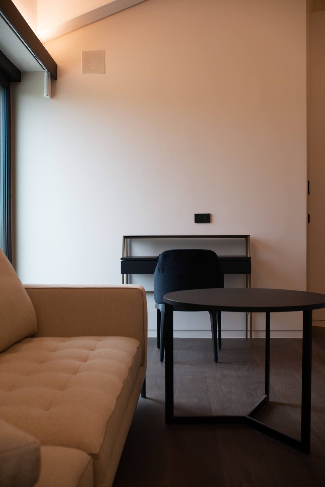 A modern living room with a sofa, a table, and a piano.
