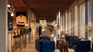 Eine moderne Lobby mit Barbereich, Sitzgelegenheiten und einem großen Fenster für natürliches Licht.