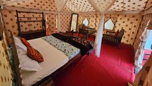 A tented room with a bed, chairs, and a red carpet. - Kumbh Village - Dining By Taj Ganges (Karchana)