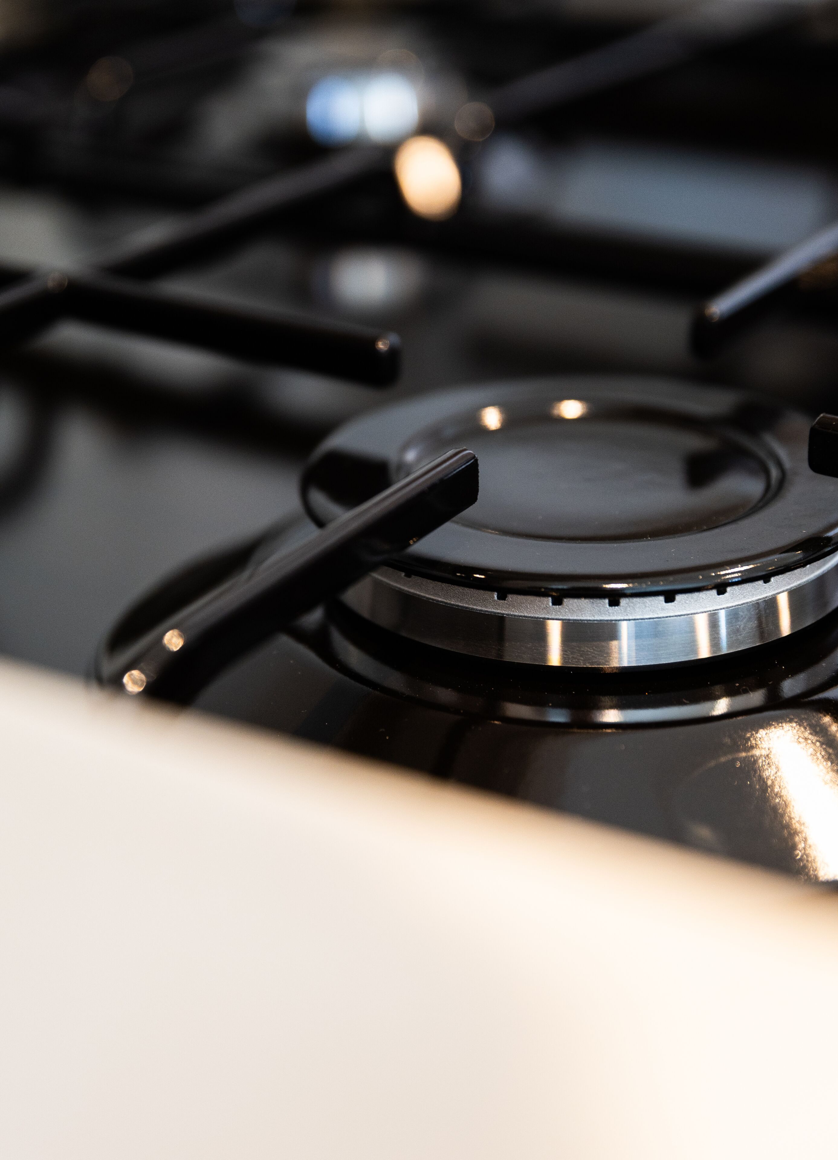 A close-up of a stove's control knobs and burners.