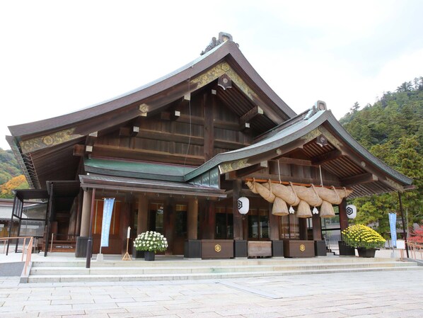 A traditional wooden building with a sloped roof and decorative elements.