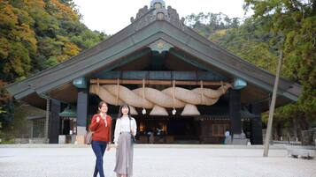 A traditional building with a tiled roof and a large entrance.