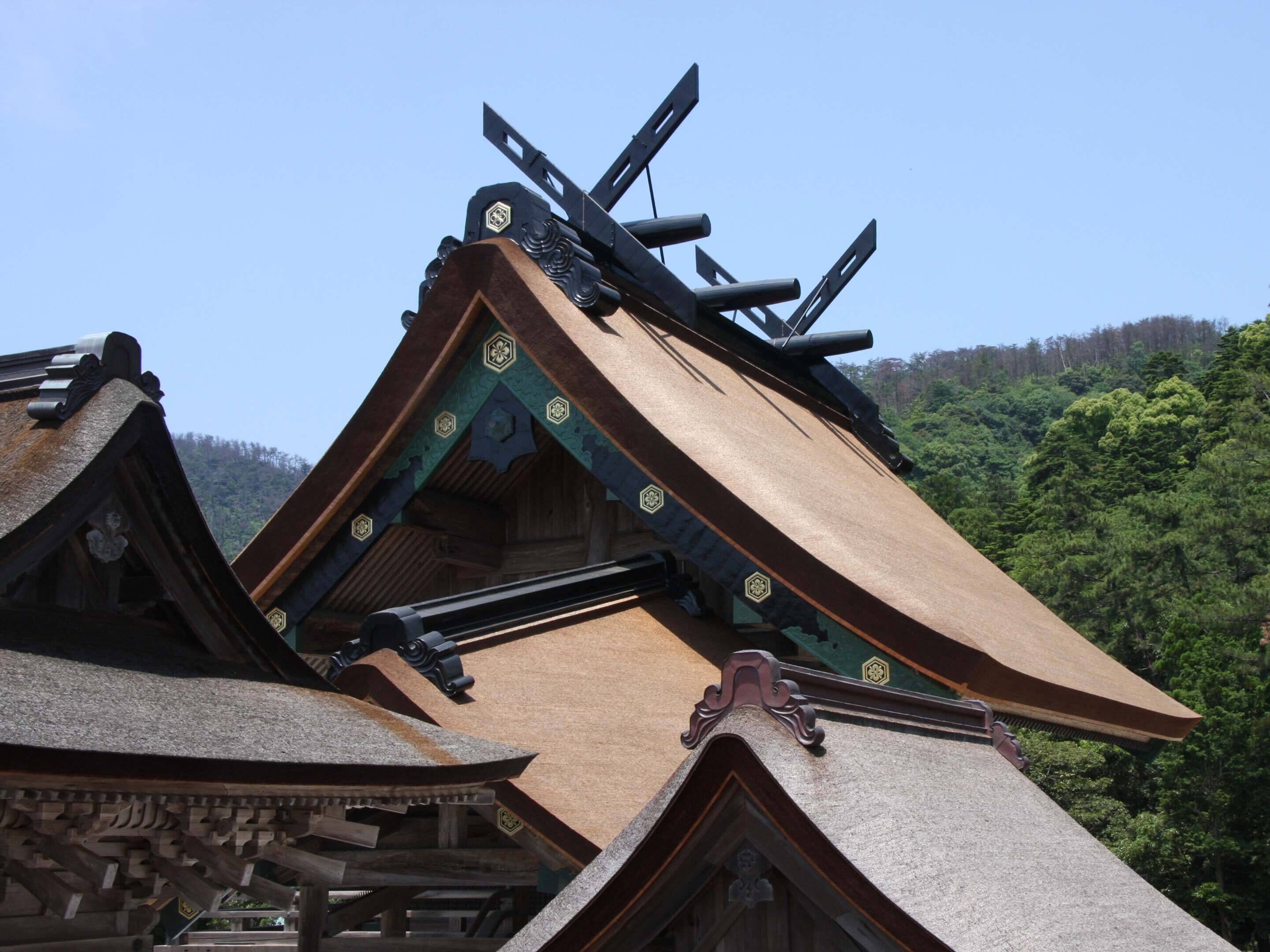 A traditional building with a steeply pitched roof and ornate wooden carvings.