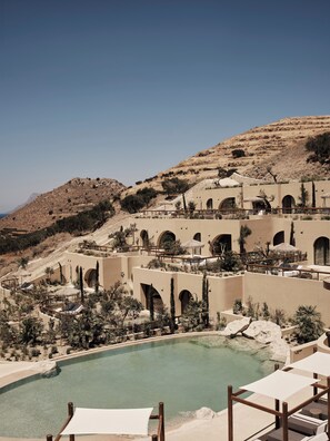 A resort with a pool, outdoor seating, and a mountainous backdrop. - Tella Thera, a Member of Design Hotels (Kissamos)