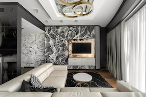 Elite-huoneisto | Olohuone | 150–senttinen taulutelevisio, jossa kaapelikanavat