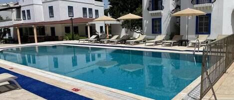 Seasonal outdoor pool, open 8:00 AM to 8:00 PM, pool umbrellas