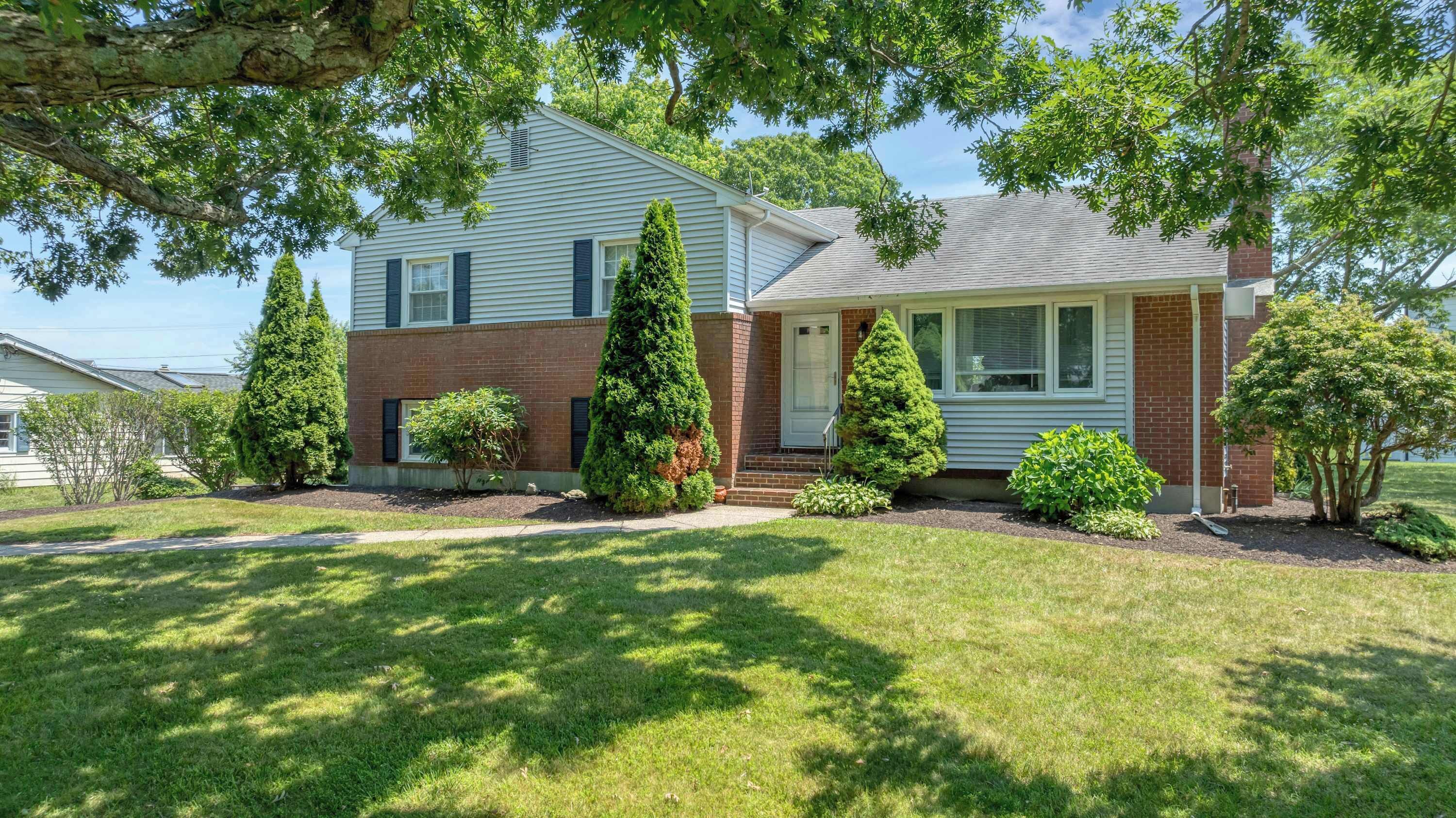 A two-story house with a brick facade and a front porch.