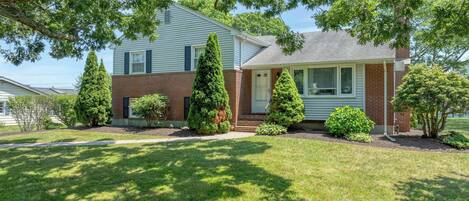 A two-story house with a brick facade and a front porch.