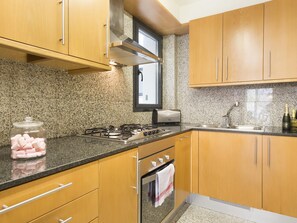 Enjoy cooking in this well-equipped kitchen with a gas stove, toaster, and sink.