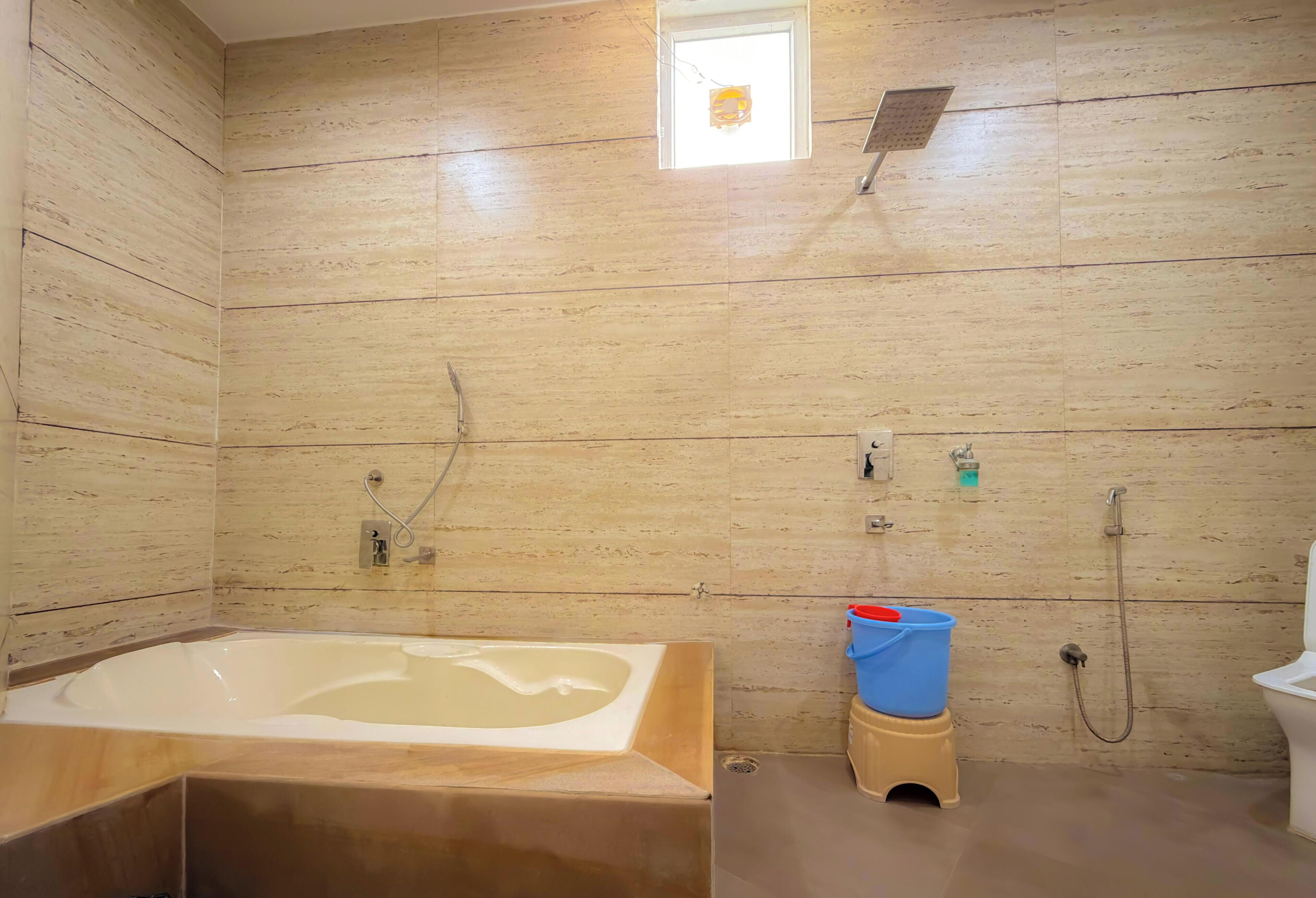 A bathroom with a bathtub, shower, and toilet.