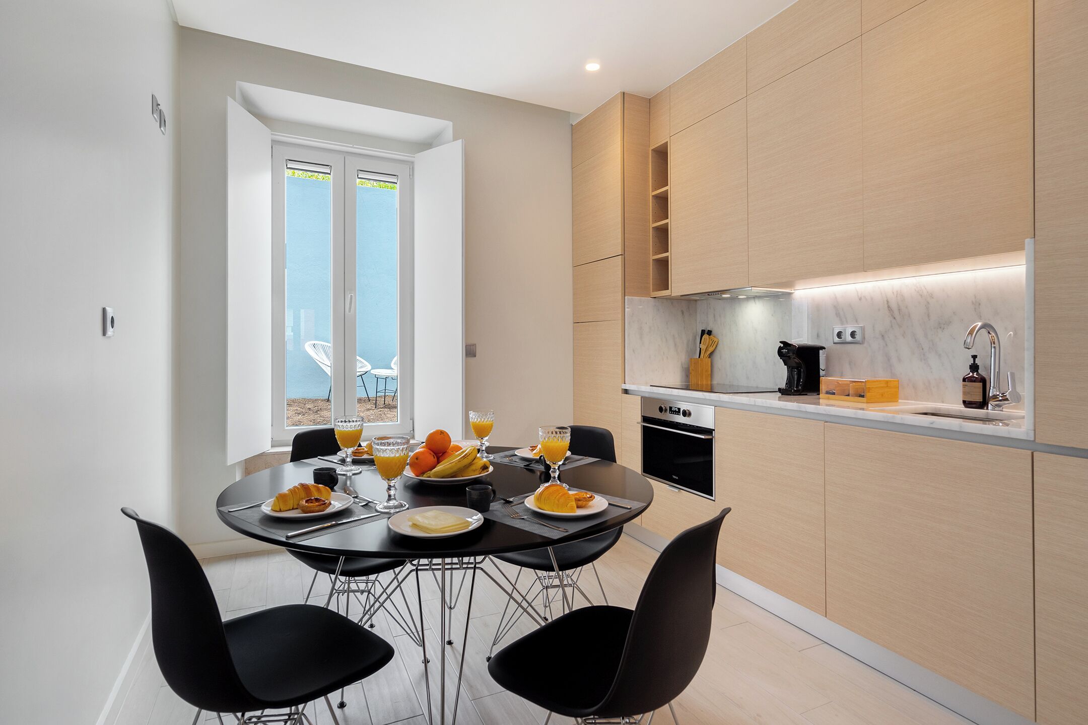 A modern kitchen with a dining area.