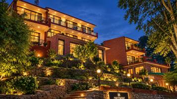 A multi-story hotel with a stone facade, multiple balconies, and a sign indicating 'Crestmont Snow View.'