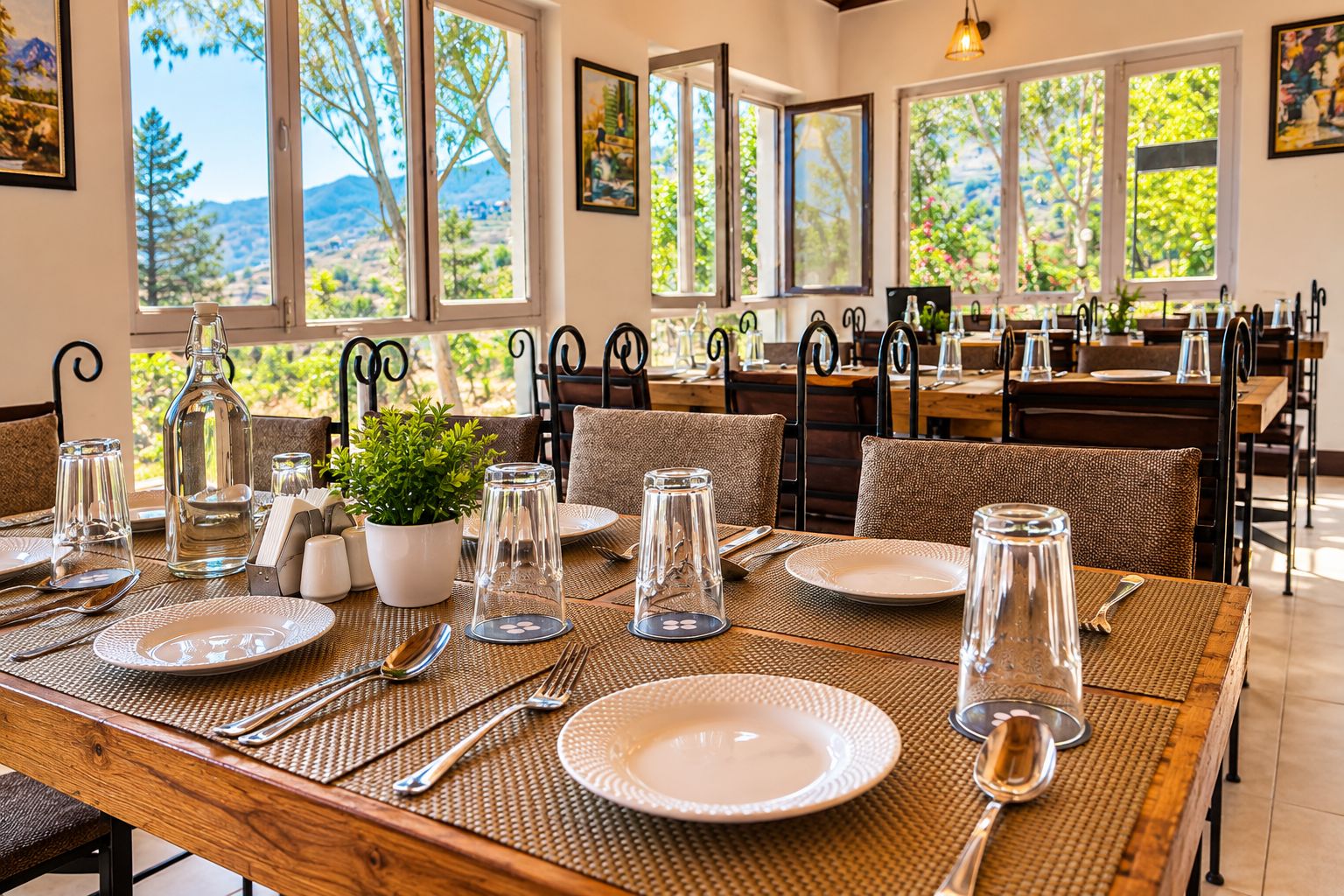 A dining area with tables set for two, featuring clear glassware, plates, and cutlery.