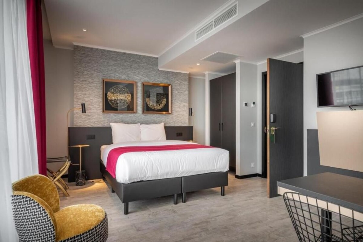 Deluxe Apartment With Balcony and kitchenette, which features a refrigerator and a mi