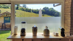 A kitchen counter with a blender, kettle, and other appliances. - 3849 Villa Daya by Barbarhouse (Fano)