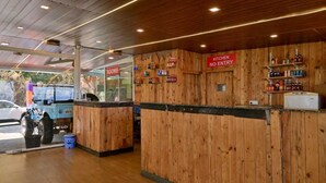 A wooden interior with a 'Kitchen No Entry' sign, a counter, and a blue vehicle outside. - The Royal Heaven by Joy Suites (Wai)