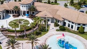 An aerial view of a hotel with a central courtyard, palm trees, and a swimming pool. - Amazing Resort Private Pool Chg102 (Davenport)
