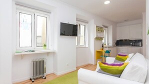 A modern apartment with a living room, kitchen, and dining area. - Hidden Gem in Alfama (Lisbon)