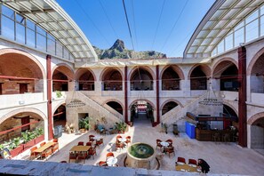 A spacious courtyard with multiple seating areas and a central fountain. - Silk Road Museum Hotel (Tokat)