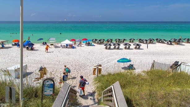 A beach with umbrellas, sun loungers, and a clear view of the ocean. - 30A Gem | Rooftop Patio | Heated Pool (Santa Rosa Beach)