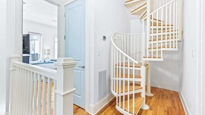 A staircase with white railings and wooden steps. - 30A Gem | Rooftop Patio | Heated Pool (Santa Rosa Beach)