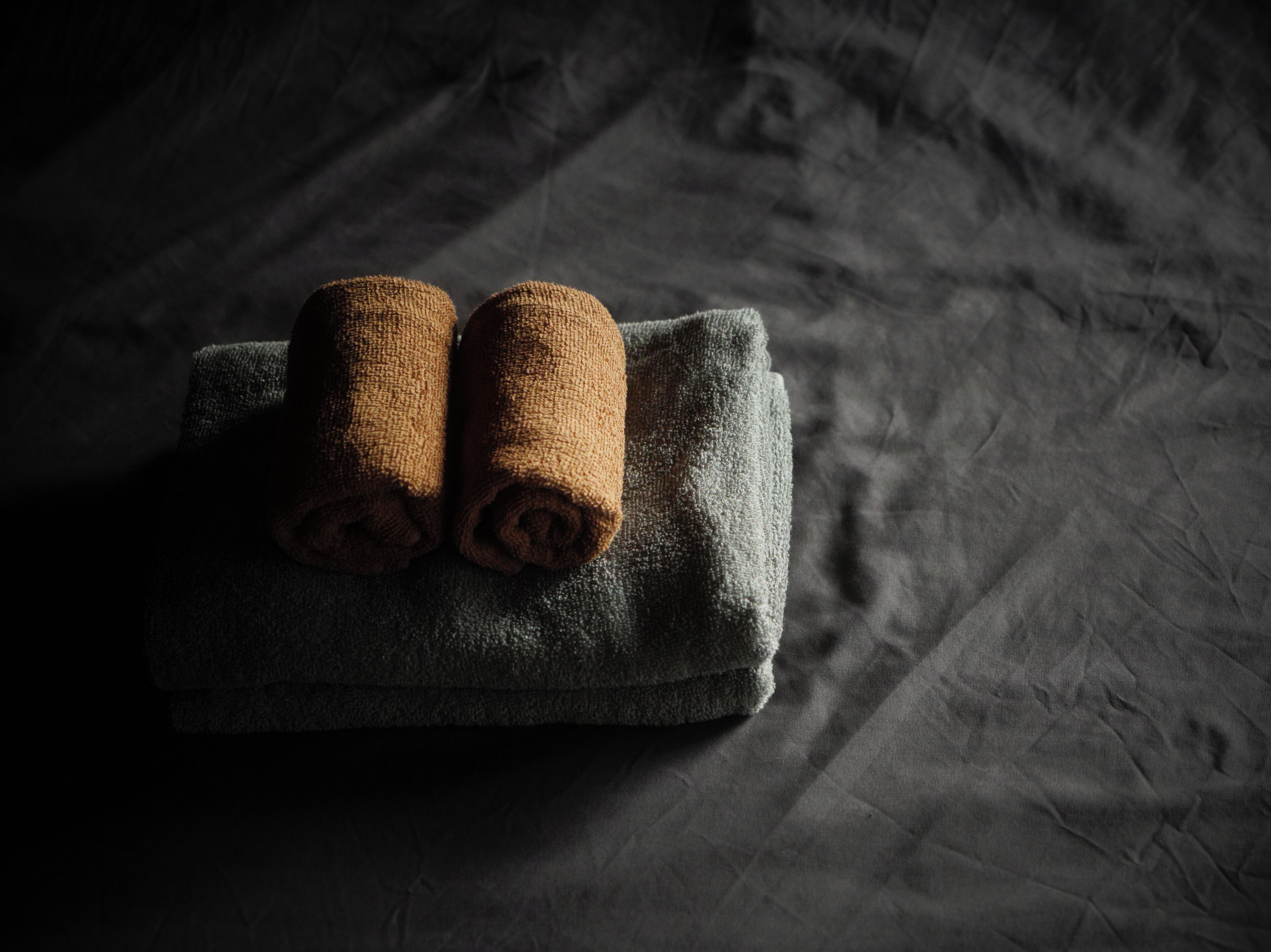 A dark-colored towel on a textured surface.
