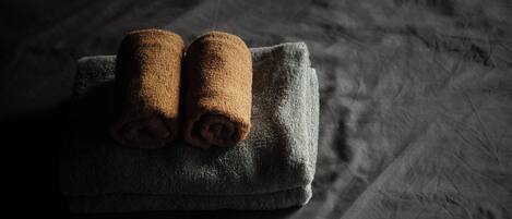 A dark-colored towel on a textured surface.