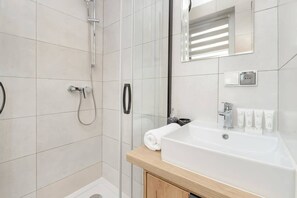 Shower, hair dryer, towels, shampoo