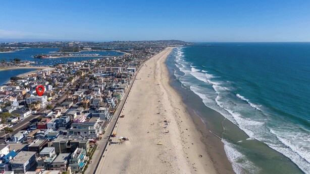 A coastal cityscape with a wide sandy beach, a marina, and residential buildings along the shoreline. - 9 Bedrooms-7 Bath-2 Kitchens-Parking-Sleeps 22! (San Diego)