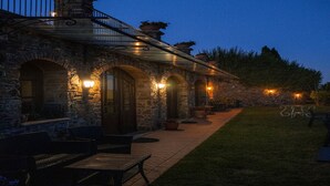 A stone building with outdoor seating and a covered patio area. - Country House in Touscany ID 4161 (Buti)