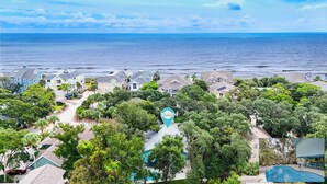 A coastal residential area with houses, a swimming pool, and a view of the ocean. - 78 Dune Lane - 2nd Row Ocean Home in NFB with Backyard Entertainment! (Hilton Head Island)