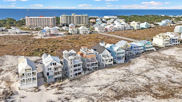 A coastal hotel area with beachfront properties, a beach, and ocean views.