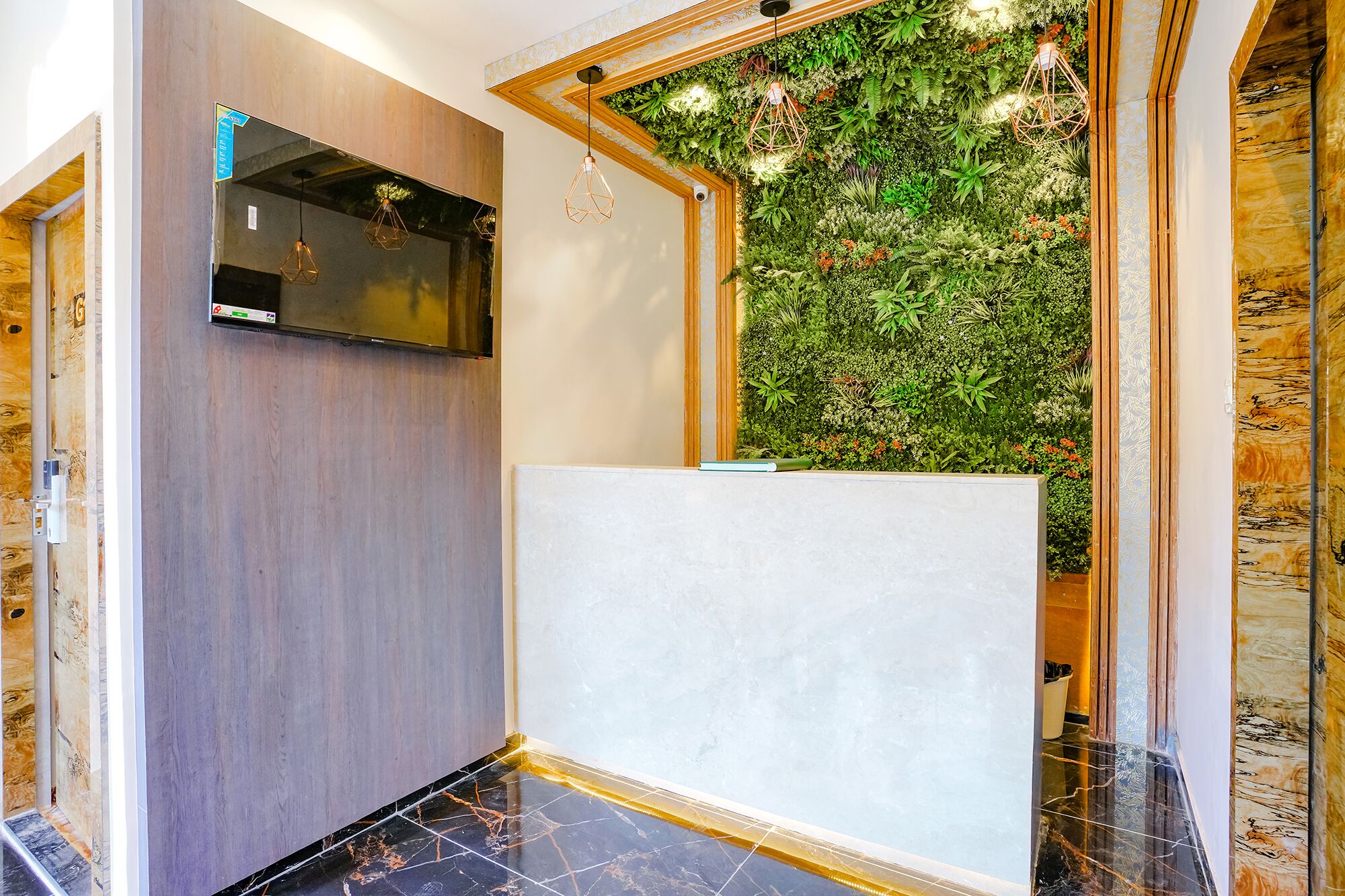 A modern interior with a wooden wall, a green wall with plants, and a marble floor.