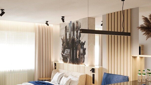 A modern hotel room with a bed, a dining table with two chairs, a cityscape artwork on the wall, and a large window with curtains. - Manhattan High Line Apart (Kyiv)