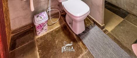 A bathroom with a sink, toilet, and shower.