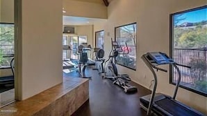 A home gym with treadmills, stationary bikes, and weights. - Exceptional upgrades makes for a perfect short or long term stay (TUCSON)