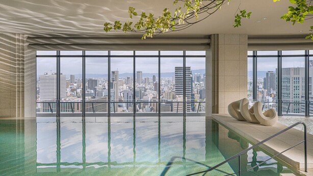 A spacious indoor pool with a city view, large windows, and modern architectural design. - Four Seasons Hotel Osaka (Osaka)