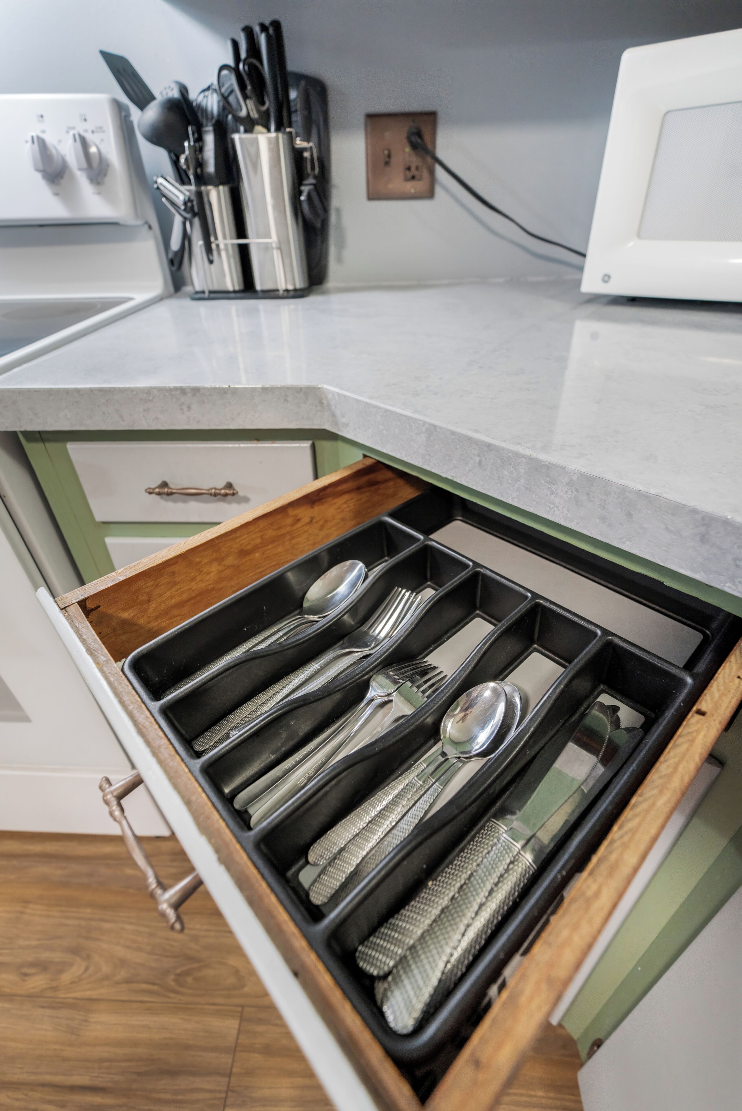 A kitchen drawer with utensils.
