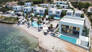 A modern resort with multiple villas, a central pool, and a beachside location. - The Palms Resort (Tkon)