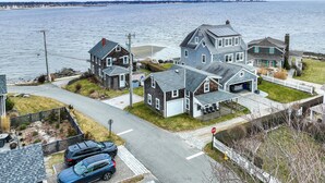 A coastal residential area with houses, a stop sign, and a road leading to the beach. - Charming Westbrook Cottage, Steps to Private Beach (Westbrook)