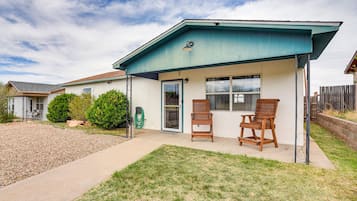 Enjoy a peaceful retreat with a covered patio area and comfortable seating for two.