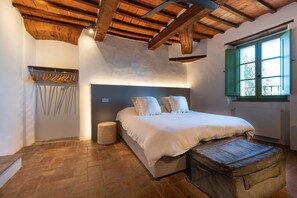 Cozy retreat with a rustic charm, featuring a bed, wicker basket, and wooden chest.