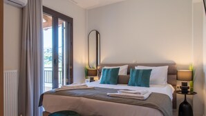 A modern hotel room with a large bed, two side tables, a mirror, and a view of the outdoors.